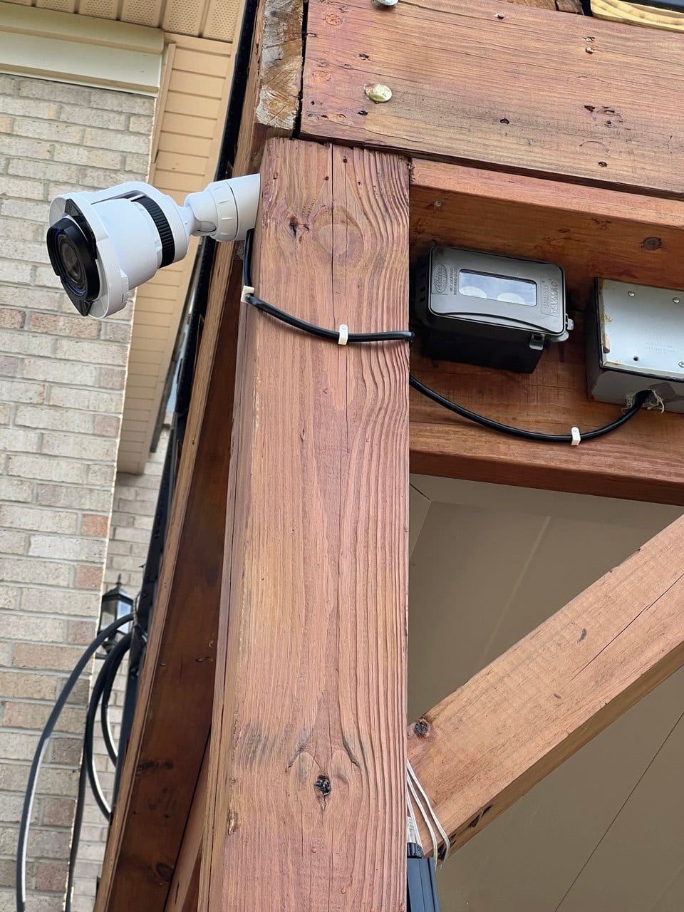 Wired security camera neatly mounted to a post and cabled back to a junction box
